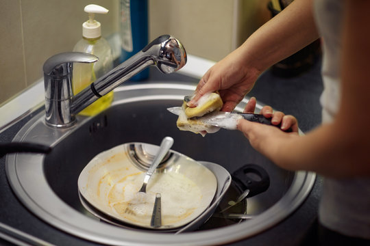Wash The Dishes In The Kitchen - Female Hand With Sponge Washing Dish.