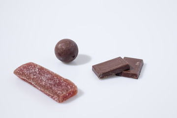 Candies and chocolate in a white background composition