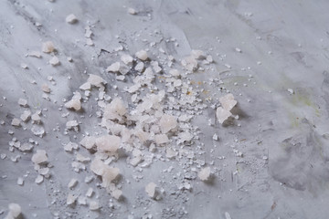 Pile of salt crystals isolated over the dark background, close-up, top view, macro, selective focus