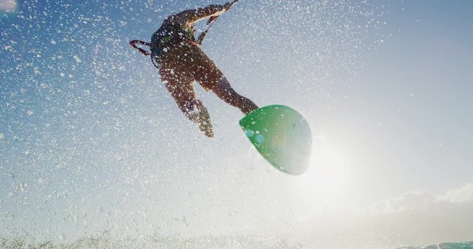 Kitesurfing at sunset in slow motion, summer fun extreme sport