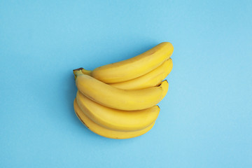 bunch of fresh bananas on yellow background
