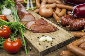Meat. Sausages, slicing carpaccio, on a wooden table knife cut meat