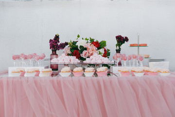 Beautiful decoration of the wedding ceremony in pink, burgundy and white tones on wooden pier....