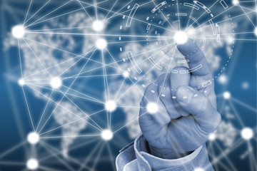 Finger touching network in front of a glowing world map
