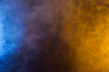 Blueand yellow smoke in dark background. Texture and desktop picture - obrazy, fototapety, plakaty