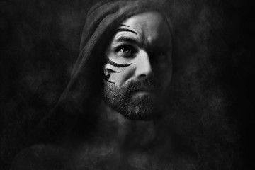 tattoo on the face,  male portrait in the form of an assassin, cosplay,  tattooed brutal man,  guy...