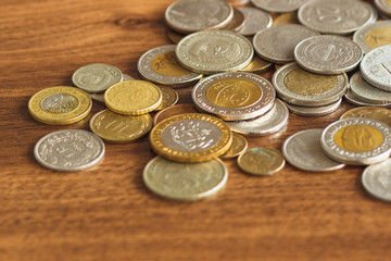 Different gold and silver collector coins on the wooden background