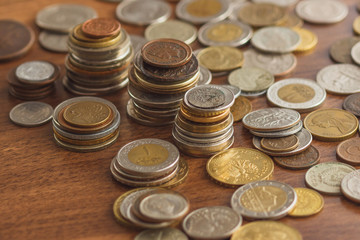 Different gold and silver collector coins on the wooden background