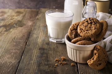 fresh healthy milk and cookies on a rustic wood background,