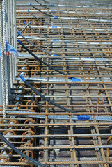 Steel reinforcement bar at the construction site. It uses to strengthen concrete. It is shaped...