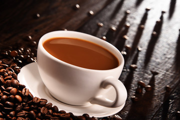 Composition with cup of coffee and beans