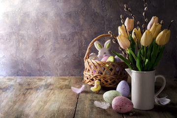 spring tulips with easter eggs on rustic background
