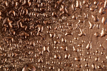 Colored water droplets on a gold background. Abstract liquid sprays