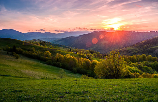 pink sunset over the mountains in springtime. gorgeous Carpathian countryside. beautiful rural scene with agricultural fields on rolling hills