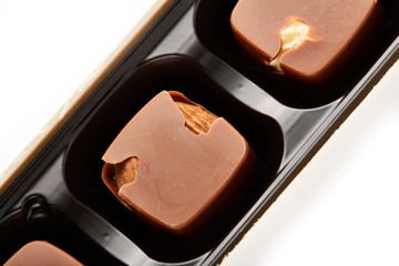 Assortment of chocolate candies sweets isolated on a white background. Chocolate candies collection. Milk chocolate with nuts.