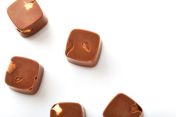 Assortment of chocolate candies sweets isolated on a white background. Chocolate candies collection. Milk chocolate with nuts.