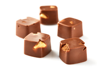 Assortment of chocolate candies sweets isolated on a white background. Chocolate candies collection. Milk chocolate with nuts.
