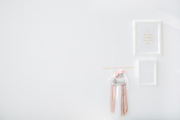 Minimal interior design concept. White wall, photo frames and decoration.