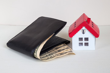 Real estate concept. Real estate and mortgage investment. Being an easy way homeowner. house and wallet  on the white  background.