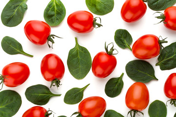 Spinach and tomato pattern background on white. Top view