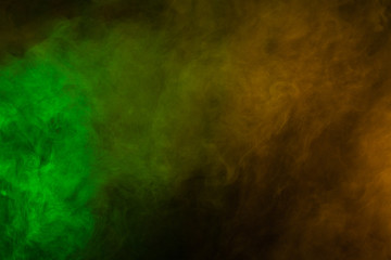 Green and yellow smoke in dark background. Texture and desktop picture