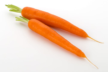 Carrot vegetable with leaves on the wooden background.