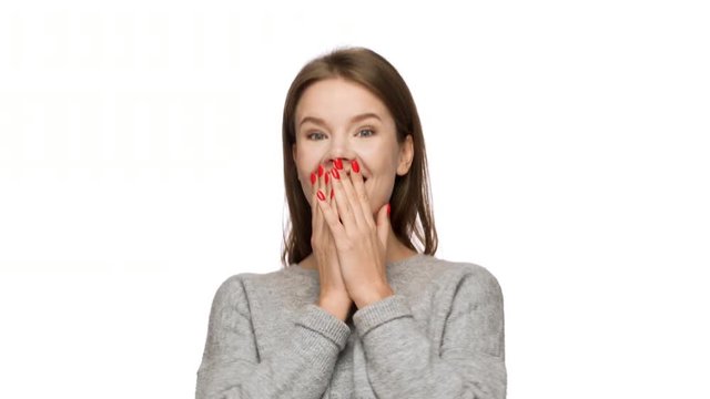 Portrait of beautiful woman with caucasian appearance expressing unexpectedness or astonishment covering mouth with hands, over white background. Concept of emotions