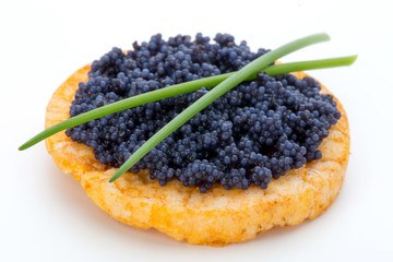 Canapes with black sturgeon caviar and  spice isolated on the white background.