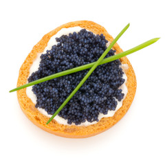 Canapes with black sturgeon caviar and  spice isolated on the white background.