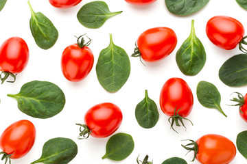 Spinach and tomato pattern background on white. Top view