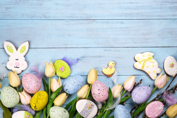 Frame of Sweets for celebrate Easter. Gingerbread in shape of easter bunny, chicken, colorful eggs and tulips