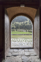  Ancient door opened and view landscape mountain catalan pyrenees,Vall de Nuria,province Girona, Catalonia.Spain.