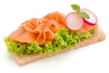 Bread with fresh salmon fillet isolated on white background, top view.