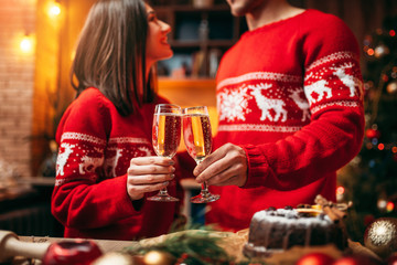 Couple holds glasses with champagne, christmas