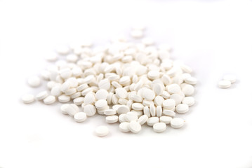 White round tablets close-up on white background