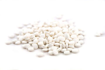 White round tablets close-up on white background