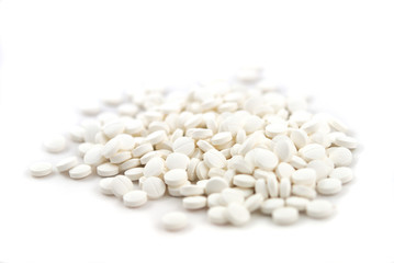 White round tablets close-up on white background