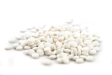 White round tablets close-up on white background