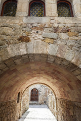 Fototapeta na wymiar Street and ancient arch in mevieval village of Pals, in Costa Brava, province Girona, Catalonia.Spain.