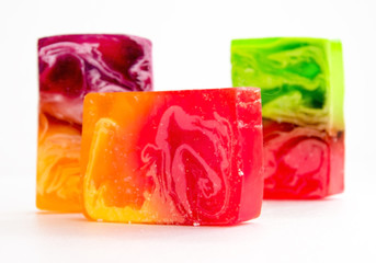 Piece of handmade bright soap. Close-up on a white background