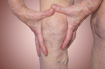 Fototapeta premium Senior woman holding the knee with pain