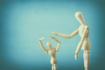 family violence cincept. wooden dummies as parents and child arguing and shouting.