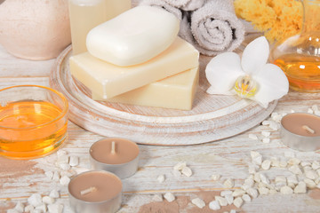 Obraz na płótnie Canvas gray natural soap with honey and body oil and a cosmetic face mask with place for tekst