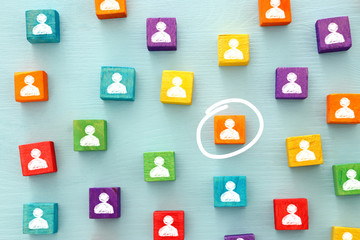 image of colorful blocks with people icons over wooden table ,human resources and management concept.