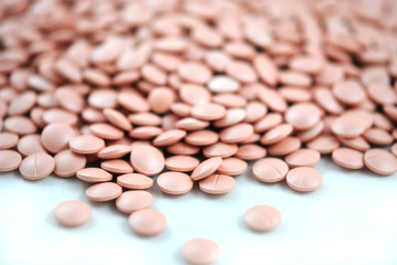 Rose round tablets close-up on white background