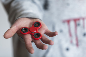 Man holding red fidget spinner 