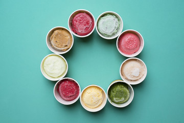Top view Ice cream flavors in cup on green background