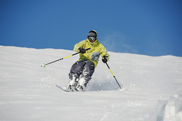 Skier running down the mountain slope in amazingly beautiful resort Gudauri, Georgia