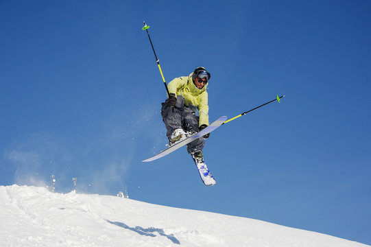 Amazing jump of skier on the mountain slope in beautiful Gudauri, Georgia