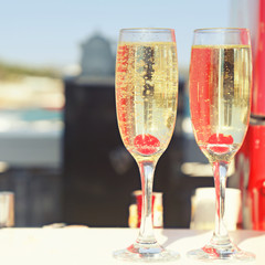 Two glasses of champagne with cherry